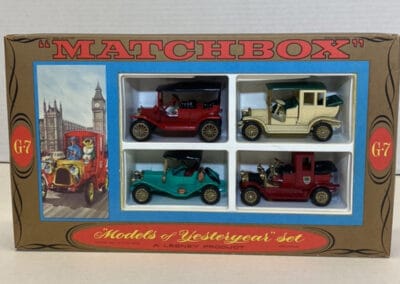 A boxed Matchbox "Models of Yesteryear" set featuring 4 vintage-style toy cars, with a background of iconic London landmarks.